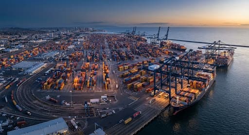 Aerial view of a modern shipping port with containers and cranes